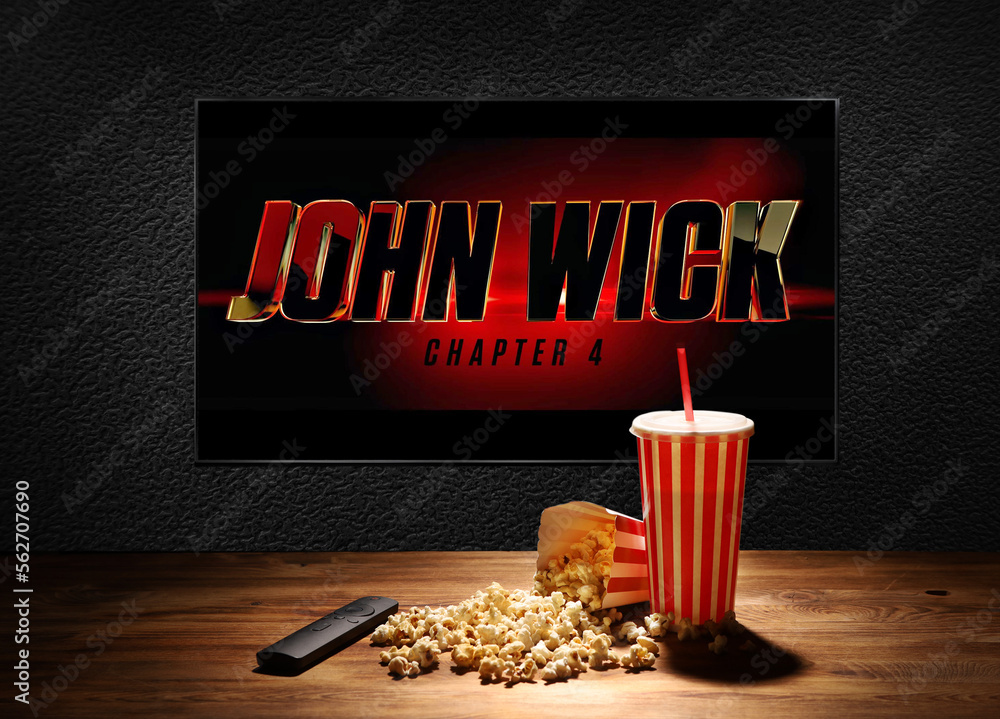 John Wick trailer or movie in TV screen. Chapter 4. Table with popcorn