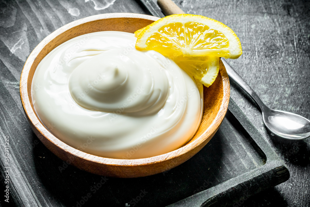 Mayonnaise on a cutting Board with lemon slices. Mayonnaise on a cutting Board with lemon slices.