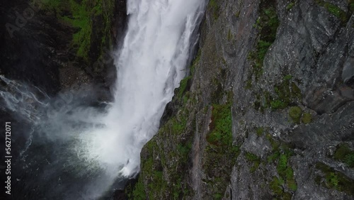 Zoom out and fly high over a waterfall in norway