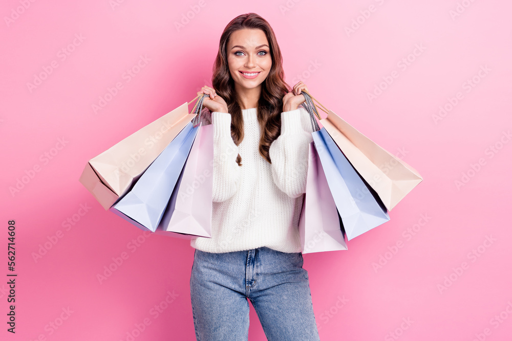 Portrait of gorgeous cheerful person toothy smile hands hold bags isolated on pink color background Portrait of gorgeous cheerful person toothy smile hands hold bags isolated on pink color background