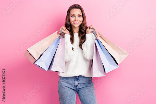 Portrait of gorgeous cheerful person toothy smile hands hold bags isolated on pink color background