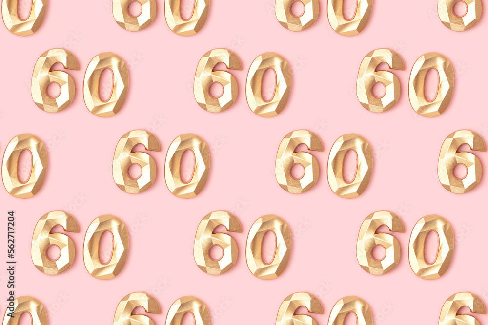 Pattern made of gold colored number sixty on a pink pastel background. Pattern made of gold colored number sixty on a pink pastel background.