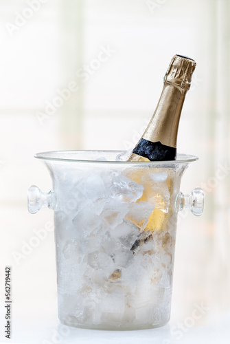 Bottle of Champagne in atransparent ice bucket
