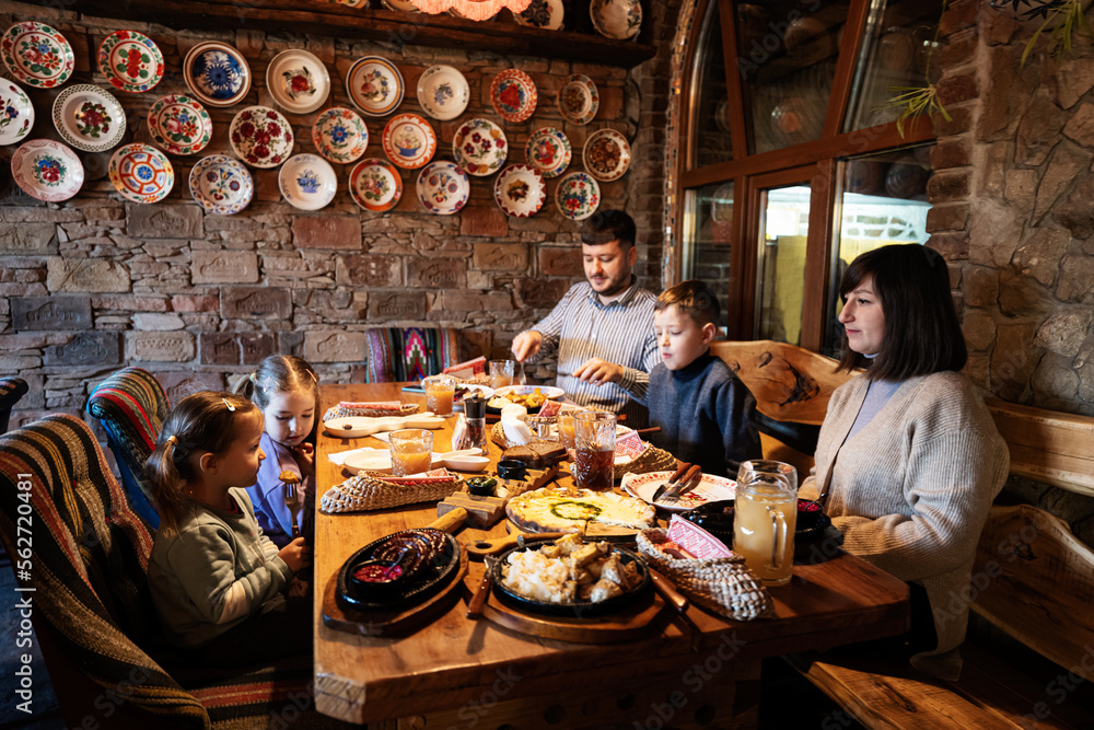 Family having a meal together in authentic ukrainian restaurant.