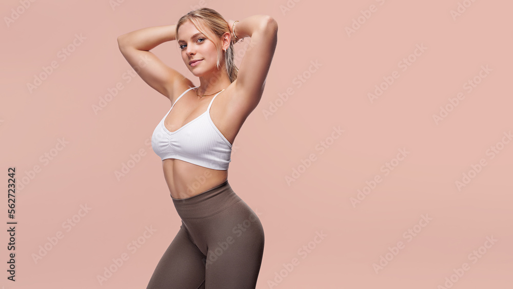 Young woman in sport wear on cool background. Fitness, diet, skin and body care Young woman in sport wear on cool background. Fitness, diet, skin and body care