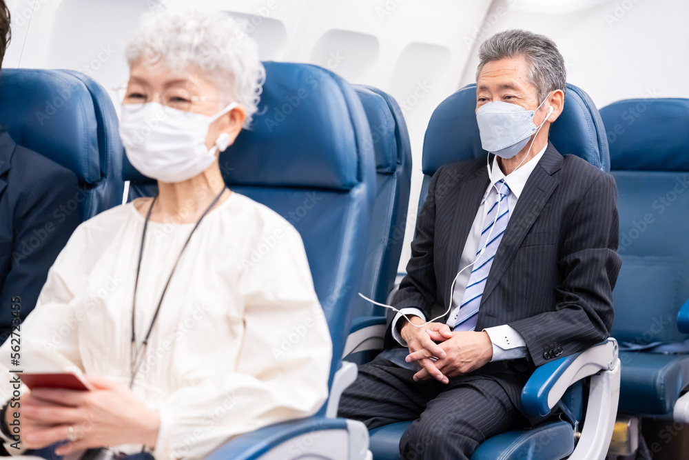 マスクをして飛行機に乗る乗客 マスクをして飛行機に乗る乗客