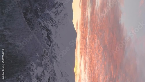 vertical video of cinematic winter sunset in beautiful snowy mountain landscape botev peak bulgaria photo