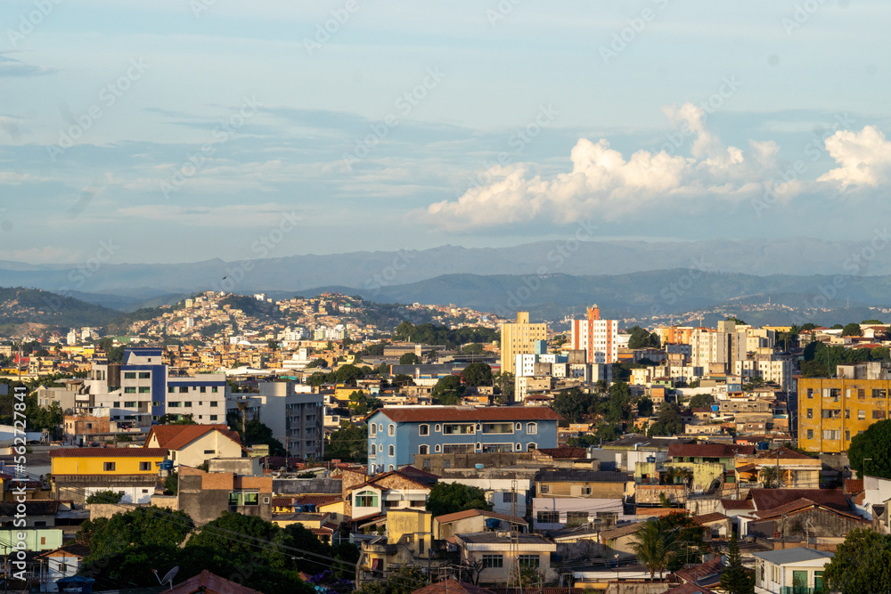 Amazing metropole with houses on small hills and horizon with mountains Amazing metropole with houses on small hills and horizon with mountains