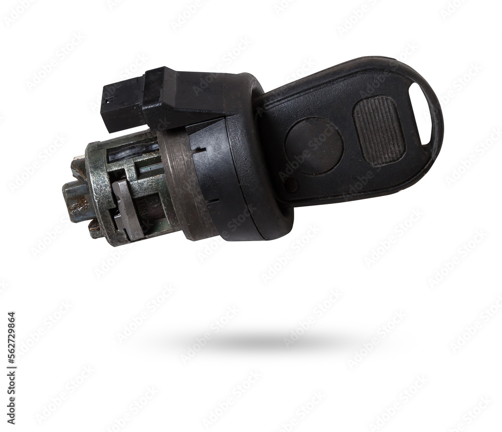 Electronic ignition lock with a key and a button made of black plastic on a white isolated background in a photography studio, a spare part for car repair or for sale in junk yard. Electronic ignition lock with a key and a button made of black plastic on a white isolated background in a photography studio, a spare part for car repair or for sale in junk yard.