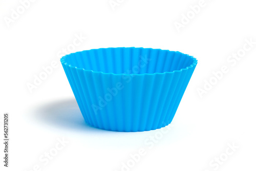 Blue silicone mold for baking a cupcake on a white background