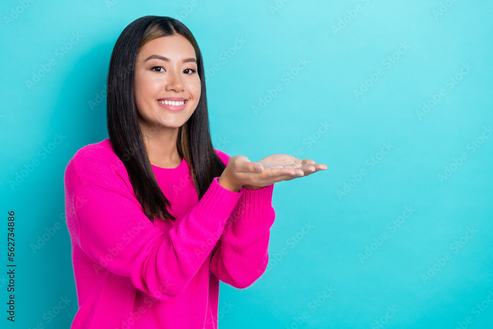 Photo of pretty cute lady wear pink clothes hands demonstrate empty space low prices discounts isolated on cyan color background Photo of pretty cute lady wear pink clothes hands demonstrate empty space low prices discounts isolated on cyan color background
