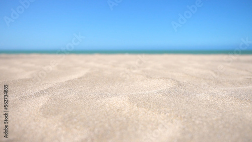 Close-up of grains of sand blowing in the wind on a bright sunny day at the tropical beach 