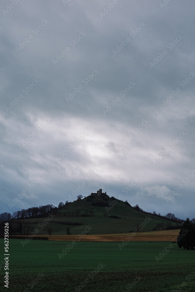 Fototapeta premium Hill with clouds and old castle ruins