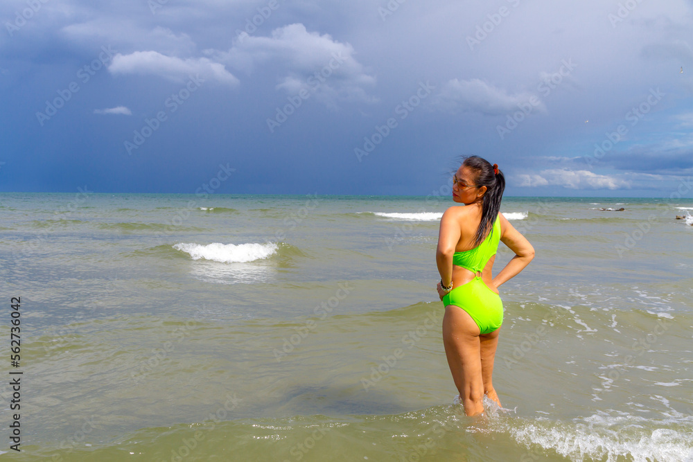Woman with swimsuit relax on wave at beach Woman with swimsuit relax on wave at beach