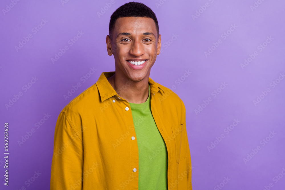 Portrait of optimistic satisfied handsome good mood man wear yellow clothes toothy smiling dental ad isolated on violet color background Portrait of optimistic satisfied handsome good mood man wear yellow clothes toothy smiling dental ad isolated on violet color background