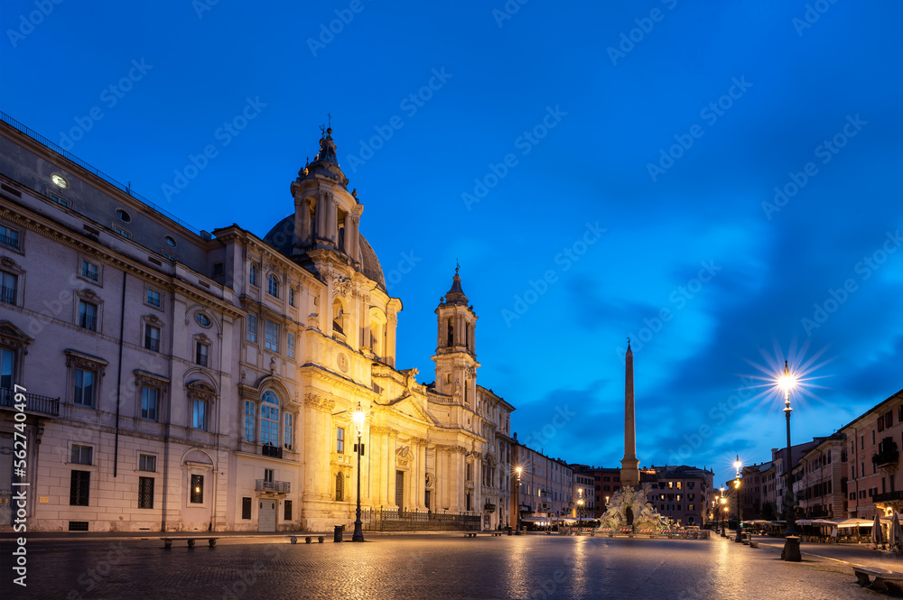Scenic view with Egyptian obelisk and Sant Agnese Church at illuminated Piazza Navona before sunrise, Rome, Italy