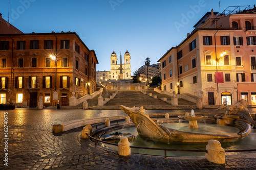 Fountain of the Boat (Fontana della Barcaccia) on Spanish square (Piazza di Spagna) at the bottom of famous Spanish stairs in Rome, Italy, at sunrise.