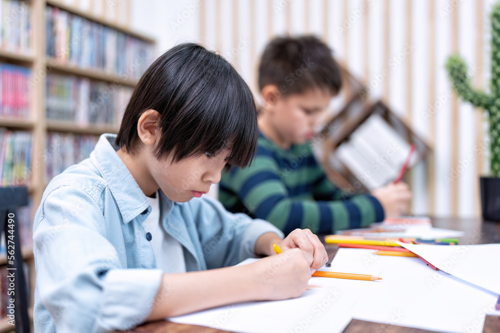 Children in class room happy laughing enjoy draw picture on paper and show to friend Children in class room happy laughing enjoy draw picture on paper and show to friend