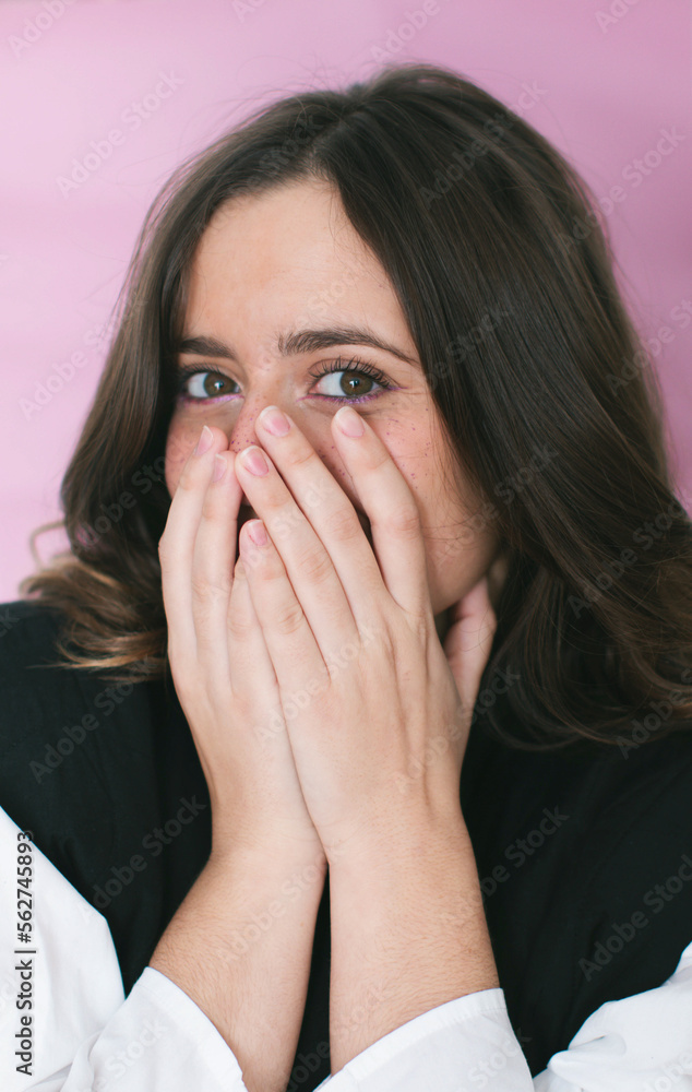 Cheerful woman covering mouth near pink background Cheerful woman covering mouth near pink background