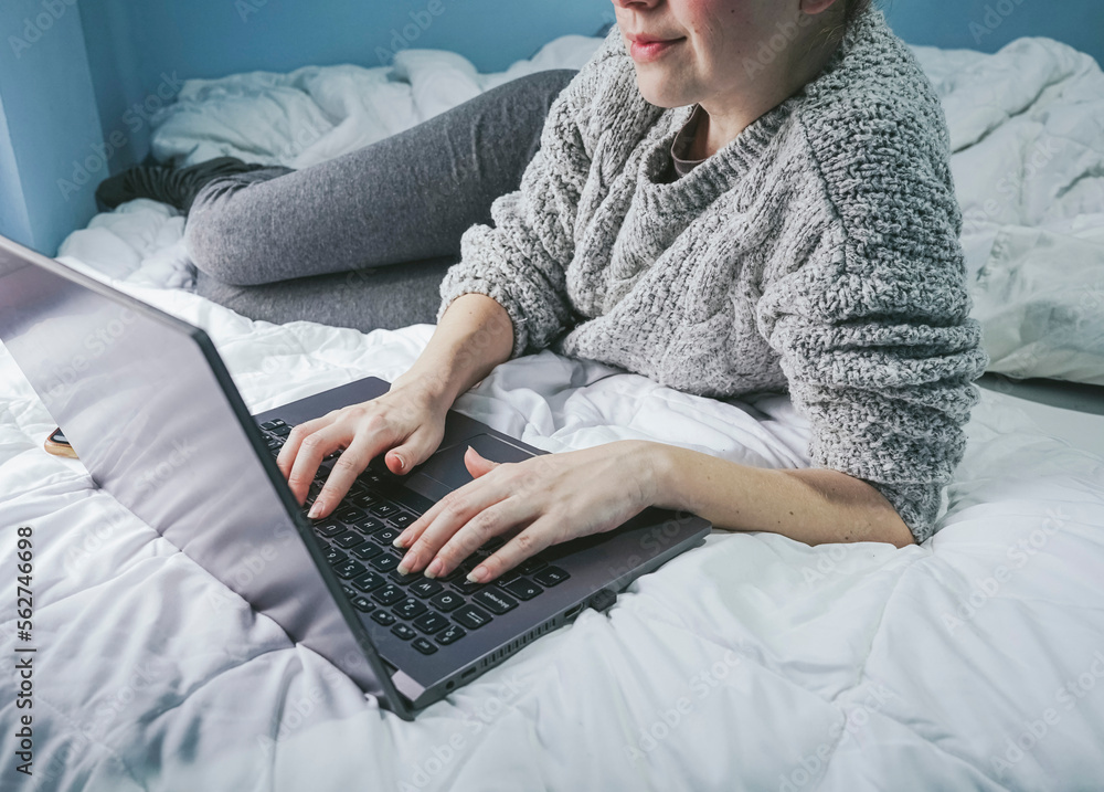 Anonymous female freelancer using computer on bed Anonymous female freelancer using computer on bed