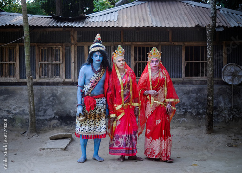 Hindu religious village people celebrating gajan festival wearing colourful costumes