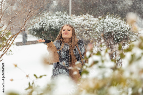 The girl is happy about the snow that has fallen
