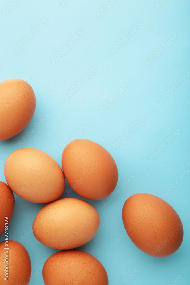 Chicken eggs on yellow background. Farm products, natural eggs. Vertical photo Chicken eggs on yellow background. Farm products, natural eggs. Vertical photo