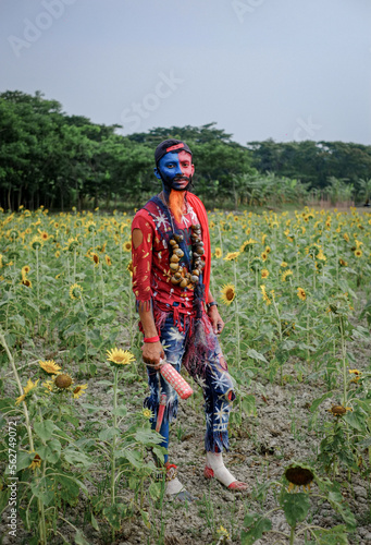 Hindu religious village people celebrating gajan festival wearing colourful costumes photo