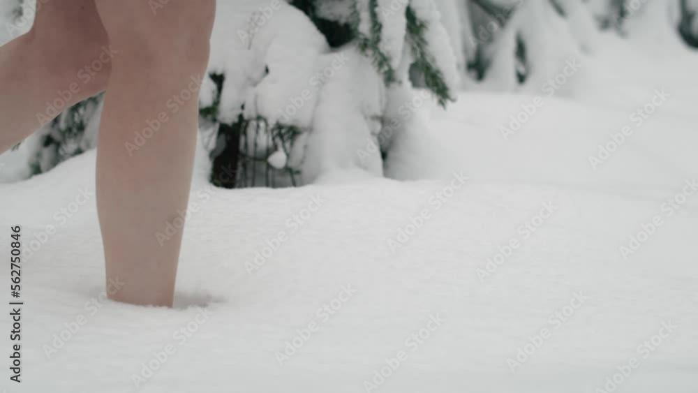 Close up of caucasian woman walking barefoot in snow. Shot with RED helium camera in 8K. Close up of caucasian woman walking barefoot in snow. Shot with RED helium camera in 8K.