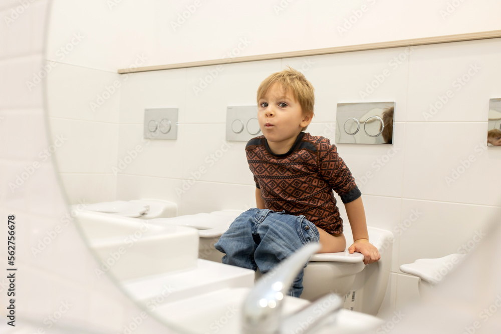 Cute child, going to toilet in kindergarden