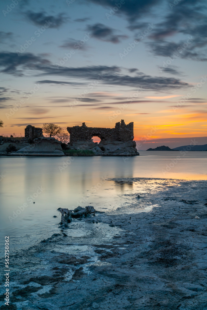 View of Old church building ruins of Bafa Lake of Aegean district at sunset with beautiful lights and colorful clouds