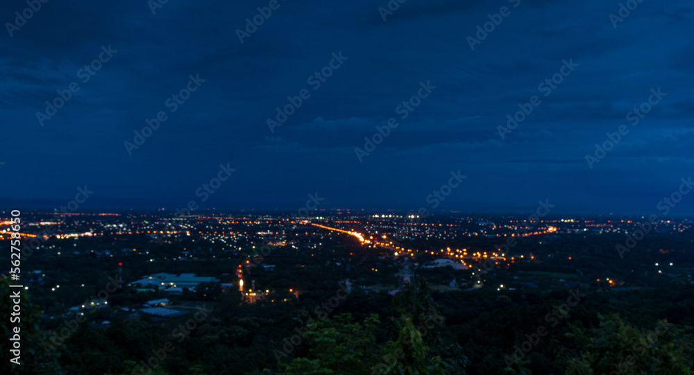 City night from the view point on top of mountain defocused background, Wat Phra That Doi Kham in Chiang mai, Thailand.	