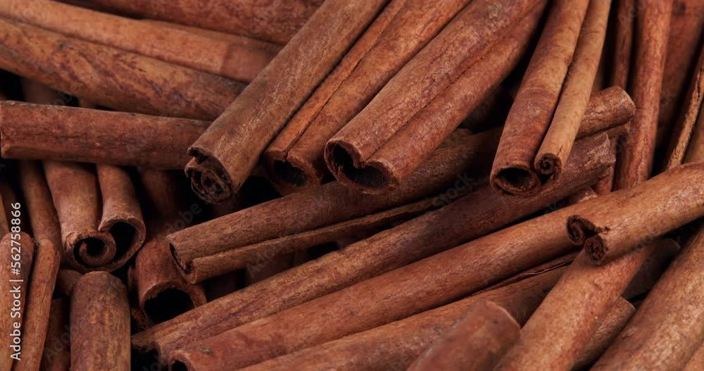 Cinnamon sticks rotate as a background. Fragrant cinnamon close-up. Spices with cinnamon. Food cooking video concept. Cinnamon sticks rotate as a background. Fragrant cinnamon close-up. Spices with cinnamon. Food cooking video concept.