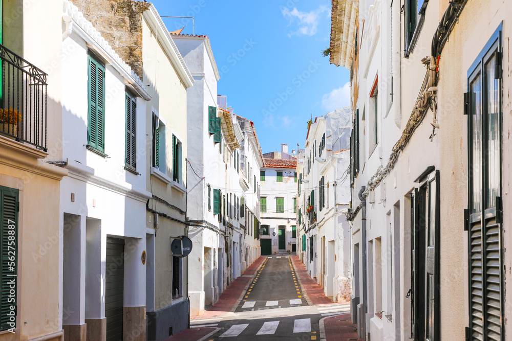 A narrow street of white houses in the city of Mahón (Maó), on the island of Menorca (Balearic Islands, Spain).