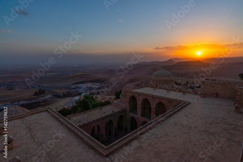Viev of Kasimiye Madrasah of Mardin Province, beautiful stone architecture religion school with colorful sunset sky with clouds