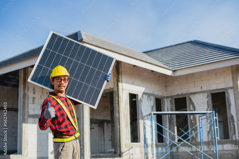 Technician holding solar panels to install on the roof of the house Technician holding solar panels to install on the roof of the house