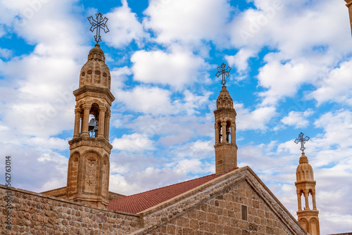 Viev of Mor Gabriel Monastery of Mardin Province, beautiful stone architecture tower wall and door with blue sky with clouds