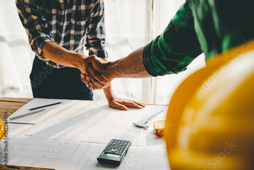 engineering team shaking hands start planning for architecture Engineer sketching construction project concept with architect equipment Consult about their construction project.