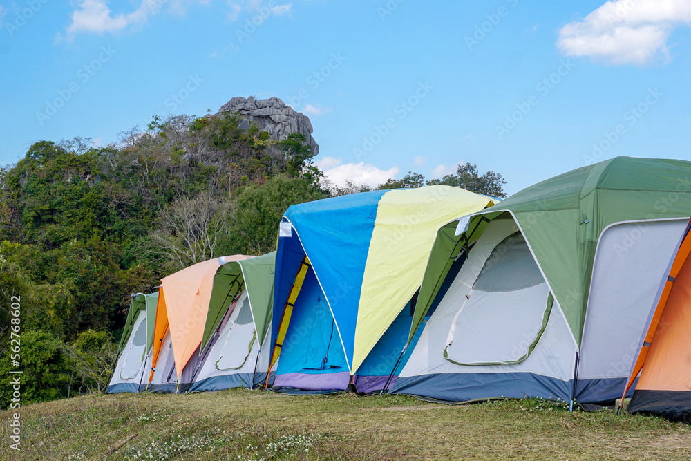 camping tent on the top of the mountain in winter in northern Thailand, view of trees, sky and clouds in clear air. Soft and selective focus.