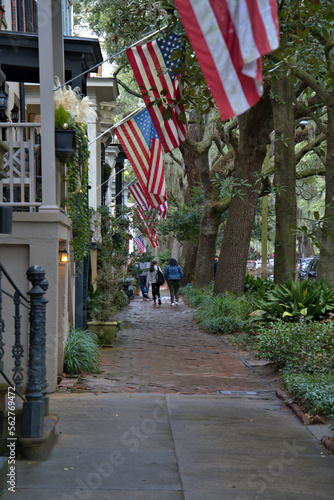 Beautiful sidewalk of flags and people walking in the distance