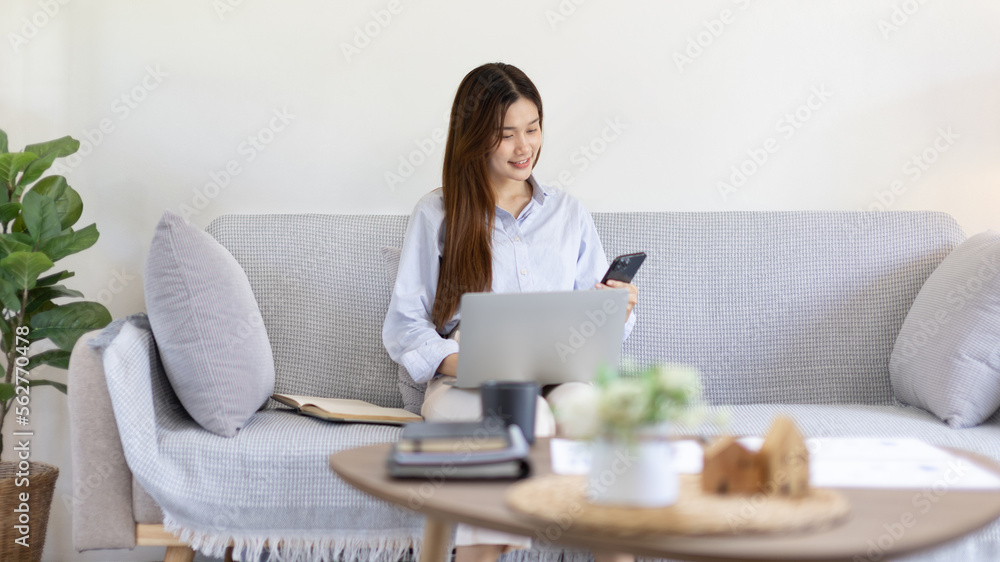 Woman working at home, Attractive woman chatting or talking with colleague on mobile phone at her home, Work for home, Remote conversation or meeting , Stay home, Use a cell phone or smartphone. Woman working at home, Attractive woman chatting or talking with colleague on mobile phone at her home, Work for home, Remote conversation or meeting , Stay home, Use a cell phone or smartphone.