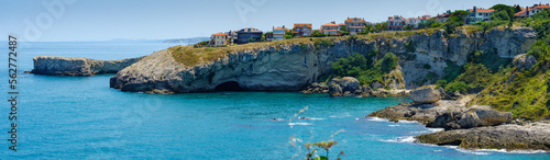 Istanbul, Turkey. The rocky shore of the Black Sea with a cave in Shila, beautiful villas on a hill. photo