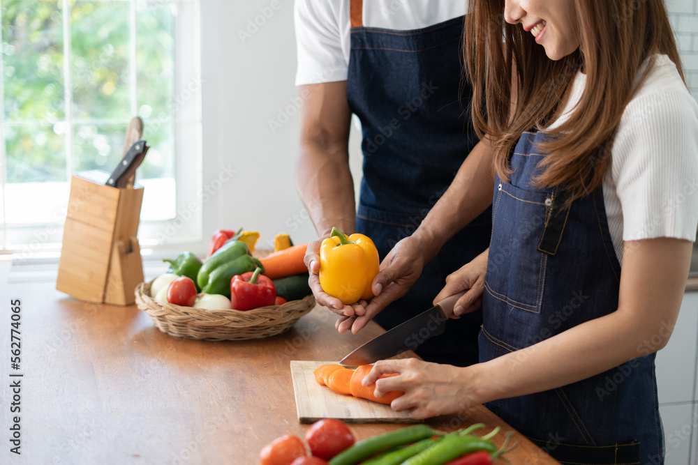 Couple cooking together. Happy young couple cooking together in the kitchen. valentine day concept. Couple cooking together. Happy young couple cooking together in the kitchen. valentine day concept.