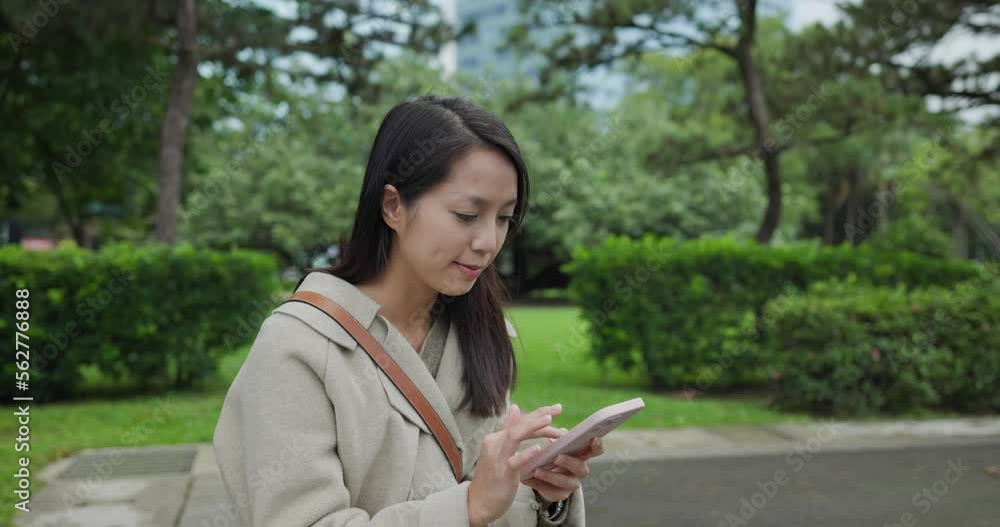 Woman use of mobile phone a park Woman use of mobile phone a park