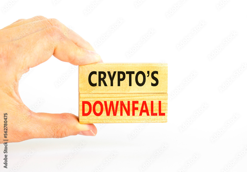Crypto downfall symbol. Concept words Cryptos downfall on wooden blocks. Beautiful white table white background. Businessman hand. Business and crypto downfall concept. Copy space. Crypto downfall symbol. Concept words Cryptos downfall on wooden blocks. Beautiful white table white background. Businessman hand. Business and crypto downfall concept. Copy space.