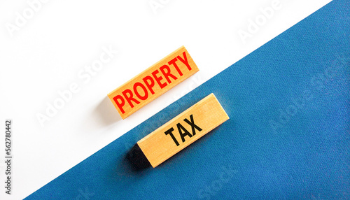 Property tax symbol. Concept words Property tax on wooden blocks. Beautiful white and blue background. Business and property tax concept. Copy space.