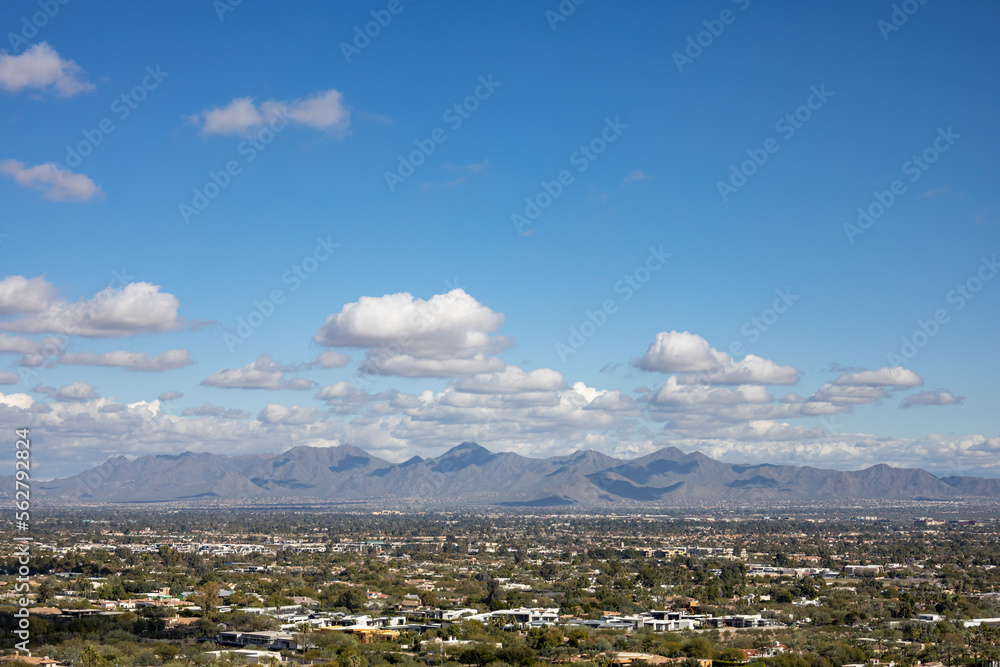 Mountains over desert city phoenix arizona cumulus clouds in the background