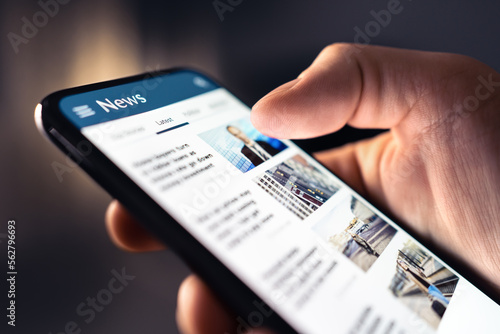 News feed in phone. Watching and reading latest online articles and headlines from smartphone newspaper mobile app. Daily digital information portal and publication. Media and press on internet. photo