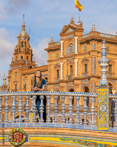 Woman Enjoying the Sunlight on the Ornate Bridge at Plaza de España, Seville, Spain