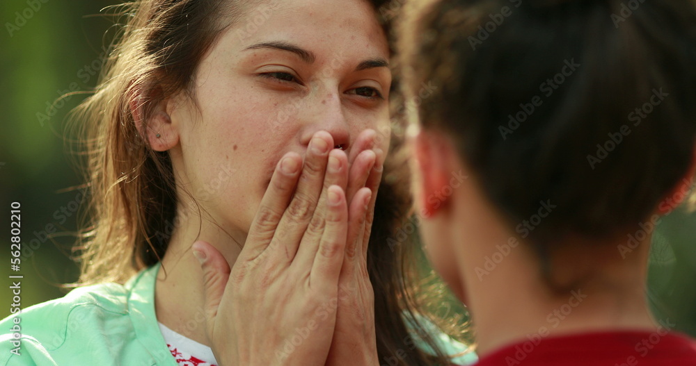 Candid young woman adjusting hair and rubbing face with hand Candid young woman adjusting hair and rubbing face with hand